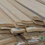 Pack of natural sliced alder veneer 2.5 mm thick with barcode labels in the warehouse.