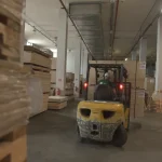 Forklift moving pallets with veneer and boards in the WoodWay Expert warehouse.