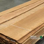 Natural sliced American cherry veneer sheets 0.6 mm thick in bundles.