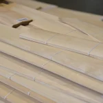 Sheets of sliced alder veneer 0.6 mm stacked to demonstrate thickness.
