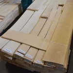 Pallet with bundles of natural sliced alder veneer in the lumber warehouse.