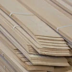 Packed bundles of sliced alder veneer 2.5 mm in the warehouse