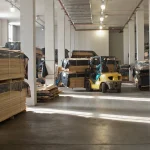 Forklift moving veneer pallets inside the WoodWay Expert warehouse