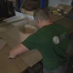 WoodWay Expert warehouse worker packing an order with sliced veneer