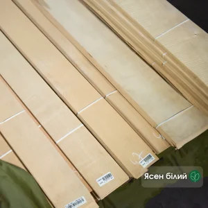 Bundles of natural sliced white ash veneer 0.6 mm thick in the warehouse