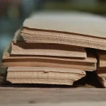 Edge view of natural sliced white ash veneer sheets showing 0.6 mm thickness