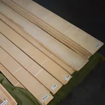 Several bundles of natural sliced white ash veneer ready for sale