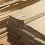 Ends of a white ash veneer bundle 0.6 mm with barcode labeling.
