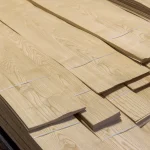 Bundles of sliced white ash veneer 0.6 mm stacked on a pallet.