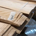 Ends of a white ash sliced veneer bundle 0.6 mm with barcode label