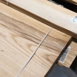 Packed bundle of sliced white ash veneer with strap and barcode