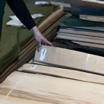 Selecting a bundle of sliced white ash veneer at WoodWay Expert warehouse