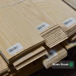 Natural sliced white ash veneer sheets 1.5 mm thick stacked in bundles at WoodWay Expert warehouse.