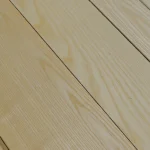 Wood grain texture of natural sliced white ash veneer sheet close-up.