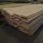 Large pallet of grade 1 sliced white ash veneer in a warehouse.