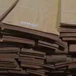 Ends of sliced white ash veneer packs showing the 2.5 mm sheet thickness.
