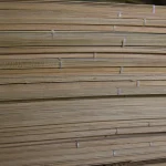 Multi-layered structure of stacked white ash veneer sheets, side view.