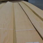Sheets of sliced white ash veneer close-up, tied with a white band.
