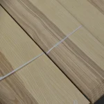 Sheets of sliced olive ash veneer bound with a white strap