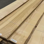 Bundles of sliced olive ash veneer stacked on a pallet