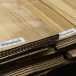 Close-up of stacked sheets of natural sliced olive ash veneer