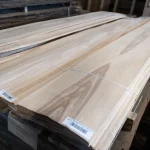Pallets with natural sliced olive ash veneer bundles at WoodWay Expert warehouse.