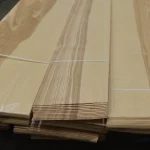 Bundled packs of sliced olive ash veneer secured with straps