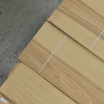 Top view of sliced olive ash veneer packs on a pallet