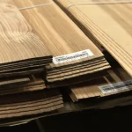 Edges of sliced olive ash veneer sheets showing 2.5 mm thickness