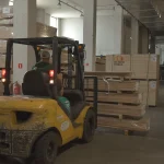 Forklift moving pallets with sliced wood veneer at WoodWay Expert warehouse
