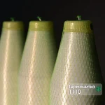 Spools of Kuper 1110 glue thread for veneer splicing on a dark background