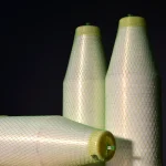 Spool of Kuper 1110 glue thread lying horizontally, showing the base and end