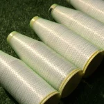 Four spools of Kuper 1220 veneer splicing glue thread lined up on a green surface.