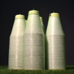 Three vertical spools of Kuper 1220 glue thread for veneer splicing on a dark background.