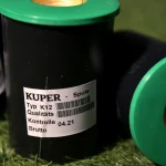 Two Kuper K12 glue thread spools, one showing the green end cap