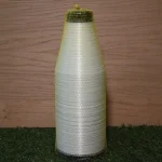 Spool of Kuper 2210 glue thread in protective mesh against wooden background