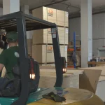WoodWay Expert warehouse with sawn veneer pallets and a forklift.